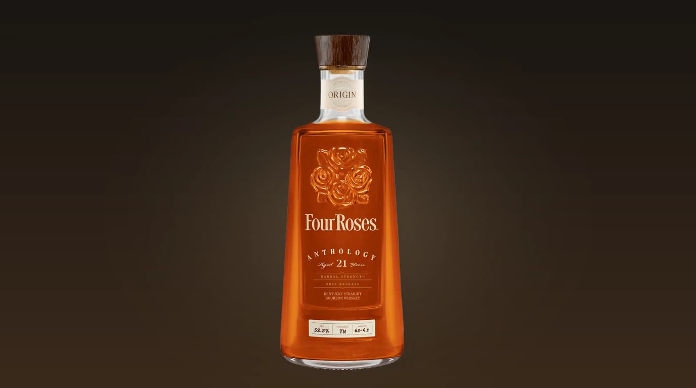 Four Roses Anthology Chapter One: Origin bottle — 21-year-old OBSF single barrel at 124.9 proof, with the embossed roses motif and Origin neck label visible against a deep charcoal editorial backdrop
