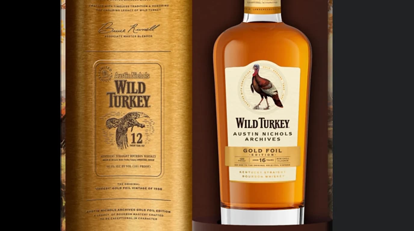 Wild Turkey Austin Nichols Archives Gold Foil Edition 16 Year bottle next to its gold canister packaging featuring the 1985 Cheesy Gold Foil 12 Year tribute design